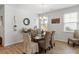 Dining room with hardwood floors, a glass table, and wicker chairs under a pendant light at 2722 Sunrose Ln, Johns Island, SC 29455