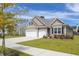 A charming single-Gathering home with a two-car garage and well-maintained lawn on a sunny day at 2722 Sunrose Ln, Johns Island, SC 29455