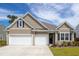 Charming home featuring a two-car garage, neutral siding, and a well-manicured front yard at 2722 Sunrose Ln, Johns Island, SC 29455