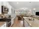 Open-concept kitchen featuring stainless steel appliances and a granite-topped island that flows into the living area at 2722 Sunrose Ln, Johns Island, SC 29455