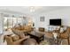 Cozy living room with a large sectional, decorative rug, and entertainment center under a ceiling fan at 2722 Sunrose Ln, Johns Island, SC 29455