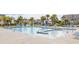 Community pool with ample seating surrounded by palm trees at 2722 Sunrose Ln, Johns Island, SC 29455