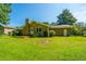Beautiful backyard with lush green lawn, brick house and new wooden deck, perfect for outdoor relaxation at 2847 Limestone Blvd, Charleston, SC 29414