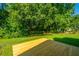 Beautiful backyard with mature trees, a lush green lawn, and new wooden deck, offering outdoor space at 2847 Limestone Blvd, Charleston, SC 29414