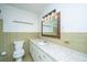 Bathroom featuring a vanity with marble countertop, decorative mirror, and ceramic tiled walls at 2847 Limestone Blvd, Charleston, SC 29414