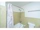 Bathroom showing a tub with shower, tile walls, toilet, and towel rack at 2847 Limestone Blvd, Charleston, SC 29414