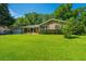Charming brick home boasts a well-kept lawn and an attached garage on a sunny day at 2847 Limestone Blvd, Charleston, SC 29414