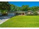 Beautiful brick home with a manicured lawn, mature trees, and an attached garage at 2847 Limestone Blvd, Charleston, SC 29414