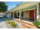 Welcoming front porch with rocking chairs, brick accents, and beautiful landscaping at 2847 Limestone Blvd, Charleston, SC 29414