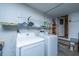Functional laundry room with modern washer and dryer, storage shelving, and ample space at 2847 Limestone Blvd, Charleston, SC 29414