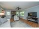 Bright and airy living room featuring a cozy brick fireplace and hardwood flooring at 2847 Limestone Blvd, Charleston, SC 29414