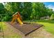 Community playground with wooden play structure, mulch base and lush landscaping at 2847 Limestone Blvd, Charleston, SC 29414