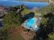 Aerial view of the community pool and hot tub, surrounded by lush landscaping and mature trees by the water at 2847 Limestone Blvd, Charleston, SC 29414