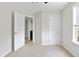 Bedroom with neutral walls, carpet, ceiling fan, window and entry to the connecting bath area at 302 Mossy Wood Rd, Summerville, SC 29483