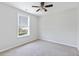 Bedroom with neutral walls, carpet, ceiling fan, and a window offering plenty of natural light at 302 Mossy Wood Rd, Summerville, SC 29483