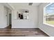 The dining area features dark hardwood floors and a window with natural light at 302 Mossy Wood Rd, Summerville, SC 29483