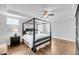 A spacious bedroom with hardwood floors, tray ceiling, fan, and windows providing natural light at 3020 River Vista Way, Mount Pleasant, SC 29466