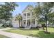 Charming two-story home featuring a spacious front yard and double front porches for enjoying the outdoors at 3020 River Vista Way, Mount Pleasant, SC 29466