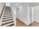 Hallway featuring wood staircase and floors, built-in shelves, and white trim at 3020 River Vista Way, Mount Pleasant, SC 29466