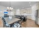 Open concept kitchen with granite countertops, an island with bar seating, and adjacent dining space at 3020 River Vista Way, Mount Pleasant, SC 29466