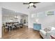 Open-concept living space featuring hardwood floors, a blue cabinet, and open flow to the kitchen at 3020 River Vista Way, Mount Pleasant, SC 29466