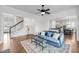 Cozy living room with a blue sofa, patterned rug, and open layout connecting to the dining and kitchen areas at 3020 River Vista Way, Mount Pleasant, SC 29466
