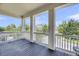 View from covered porch overlooking neighborhood street with white railings and support columns at 3020 River Vista Way, Mount Pleasant, SC 29466