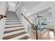 Staircase leading to the second floor, with views of the living room and natural light at 3020 River Vista Way, Mount Pleasant, SC 29466