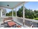 Charming balcony with seating area, white railings, and view of lush green trees at 312 Barberry St, Summerville, SC 29483