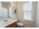 Bathroom featuring a wood vanity, a large window, and shower with white curtain at 312 Barberry St, Summerville, SC 29483