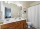 Bright bathroom featuring a double sink vanity, a large mirror, and a shower with curtain at 312 Barberry St, Summerville, SC 29483