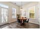 Cozy breakfast nook with a round table, modern chairs, and view of the outdoors through bright windows at 312 Barberry St, Summerville, SC 29483