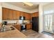 Well-lit kitchen with modern appliances, wood cabinets, and a view to an adjacent outdoor space at 312 Barberry St, Summerville, SC 29483