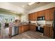 Spacious kitchen with stainless steel appliances and wooden cabinets, seamlessly connecting to the dining and living areas at 312 Barberry St, Summerville, SC 29483