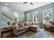 Bright living room featuring a plush sectional sofa, a patterned rug and light-colored walls with decorative trim at 312 Barberry St, Summerville, SC 29483