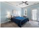 Serene bedroom with blue walls, a comfortable bed, and a door leading to a private balcony at 312 Barberry St, Summerville, SC 29483