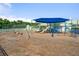 Community playground featuring swings and play structures under a blue sunshade, perfect for Gathering fun at 312 Barberry St, Summerville, SC 29483