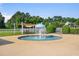 Community pool with a central water fountain feature, seating, and shaded areas, creating a fun, Gathering environment at 312 Barberry St, Summerville, SC 29483
