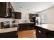 Modern kitchen featuring black cabinets, stainless steel appliances, and granite countertops at 312 Kelsey Blvd, Wando, SC 29492