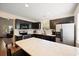 Modern kitchen featuring dark cabinets, stainless steel appliances, and a breakfast bar with quartz countertops at 312 Kelsey Blvd, Wando, SC 29492