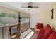 Relaxing screened porch featuring wicker furniture, wooden floors, and a ceiling fan at 312 Kelsey Blvd, Wando, SC 29492