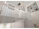 Bright staircase features white banisters, leading to an open landing with modern light fixture and wall art at 312 Kelsey Blvd, Wando, SC 29492