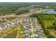 Expansive aerial view of a residential community featuring single-Gathering homes, lush landscaping, and tranquil ponds at 3274 Arrow Arum Dr, Johns Island, SC 29455