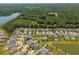 An aerial view of the community shows homes, ponds, green space, and surrounding nature at 3274 Arrow Arum Dr, Johns Island, SC 29455