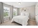 Cozy bedroom with white bedding, neutral walls, and natural light from two windows at 3274 Arrow Arum Dr, Johns Island, SC 29455