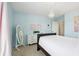 Stylish blue bedroom features a full size bed, chandelier, and lots of light at 3274 Arrow Arum Dr, Johns Island, SC 29455