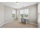 Well-lit bedroom with neutral carpet, white desk, and chair at 3274 Arrow Arum Dr, Johns Island, SC 29455