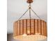 Close-up of a woven chandelier, adding a touch of rustic charm and warm lighting to the space at 3274 Arrow Arum Dr, Johns Island, SC 29455