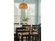 Bright dining area with large windows, a wooden table, and decorative light fixture is shown at 3274 Arrow Arum Dr, Johns Island, SC 29455