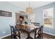 Inviting dining room features a wooden table set with seating for eight and a stylish woven light fixture at 3274 Arrow Arum Dr, Johns Island, SC 29455